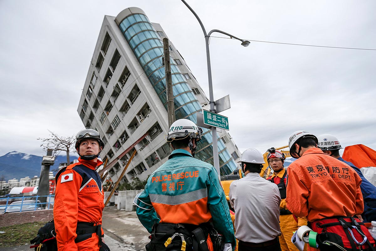 Japanische Rettungskräfte nehmen am 9. Februar 2018 die Suche nach vermissten Personen beim Wohnkomplex «Yunmen Cuiti Building» in Hualien, Taiwan, wieder auf. Zwei Tage zuvor hatte ein Erdbeben der Stärke 6,4 das Gebäude zerstört. Foto: Keystone-SDA, epa / Ritchie B. Tongo